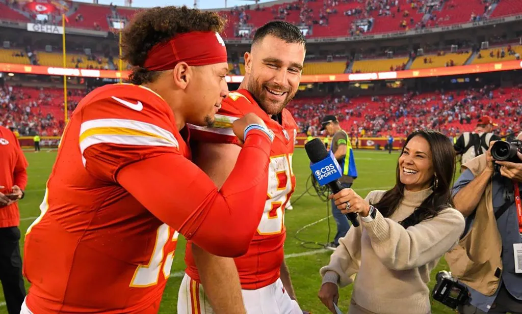 Kansas City Chiefs tight end Travis Kelce (87) laughs as quarterback Patrick Mahomes (15) interrupts a TV interview after defeating the Los Angeles Chargers, 31-17, at GEHA Field at Arrowhead Stadium on Oct. 23, 2023, in Kansas City, Missouri.