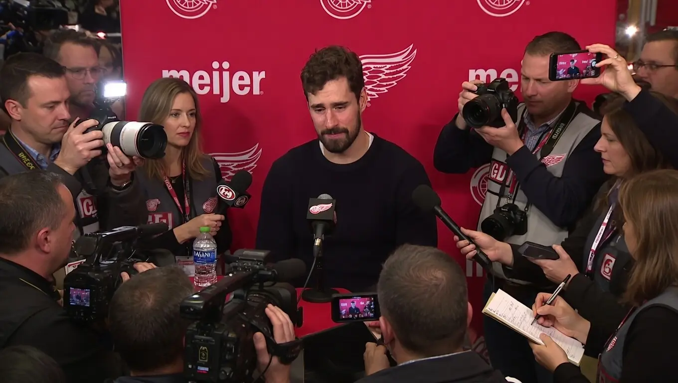 Cover Image for “HE’S ONLY 24 YEARS OLD” — Detroit Red Wings captain Dylan Larkin struggled to hold back tears as he spoke about Moritz Seider’s situation following the intense backlash from Detroit Red Wings fans after the loss to the Boston Bruins.